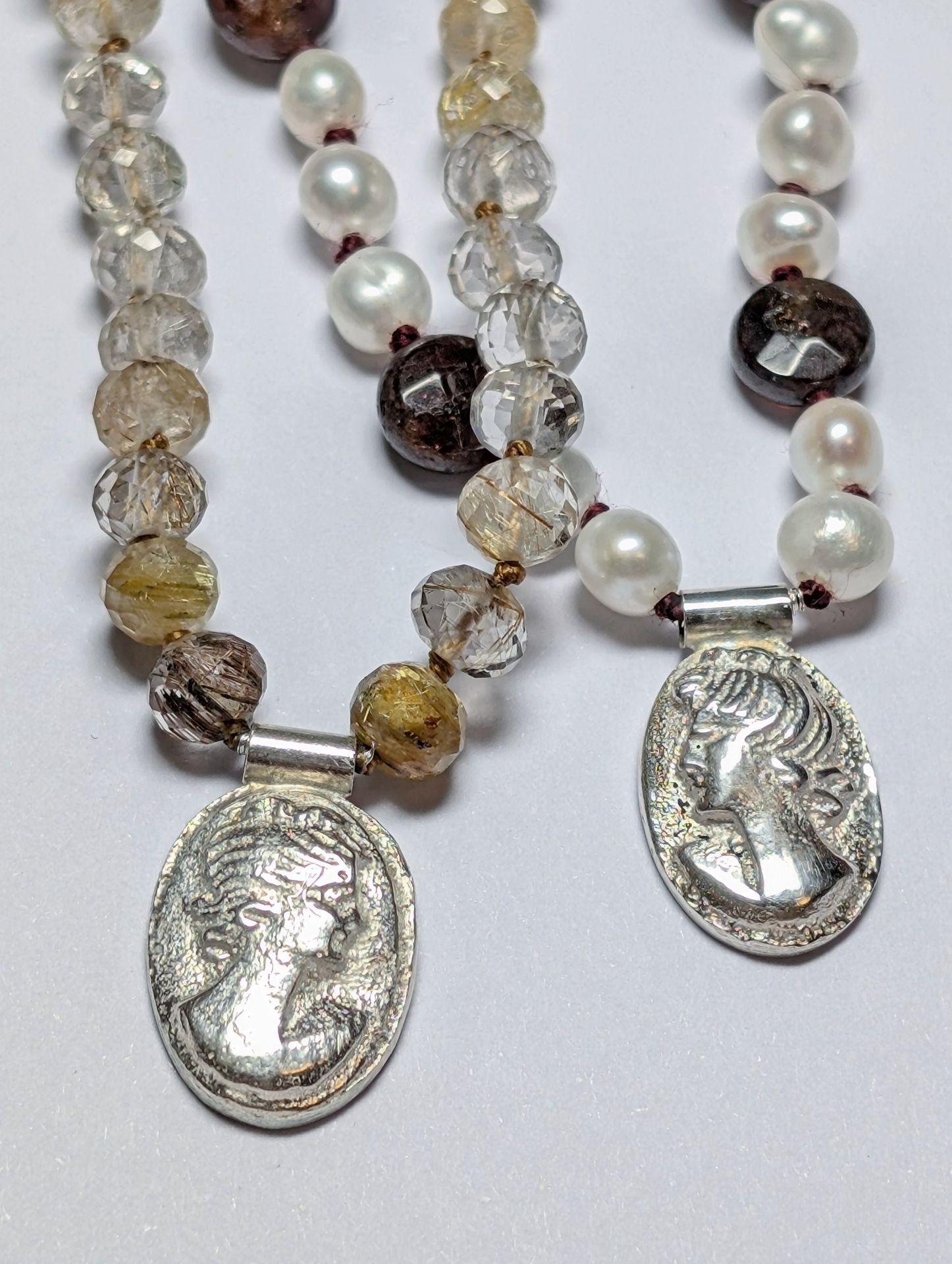 Knotted pearl, quartz and garnet necklaces with silver cameo pendants