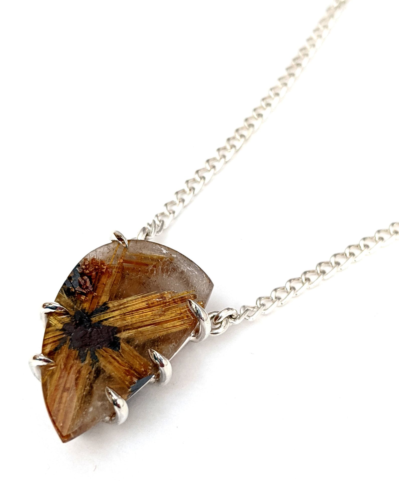 Claw-set rutilated quartz pendant on a silver chain