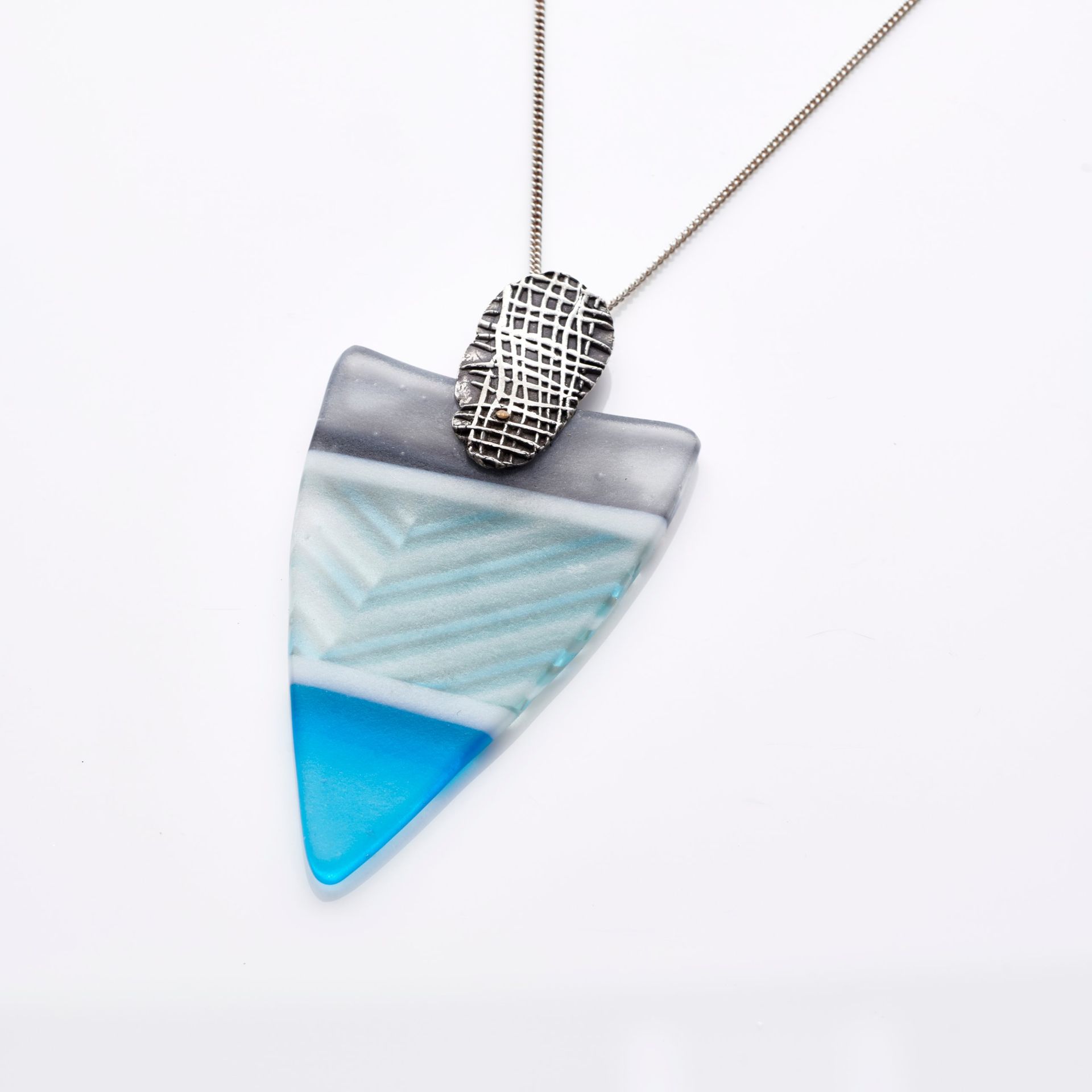 Triangular fused glass pendant in grey and turquoise with a textured silver bail