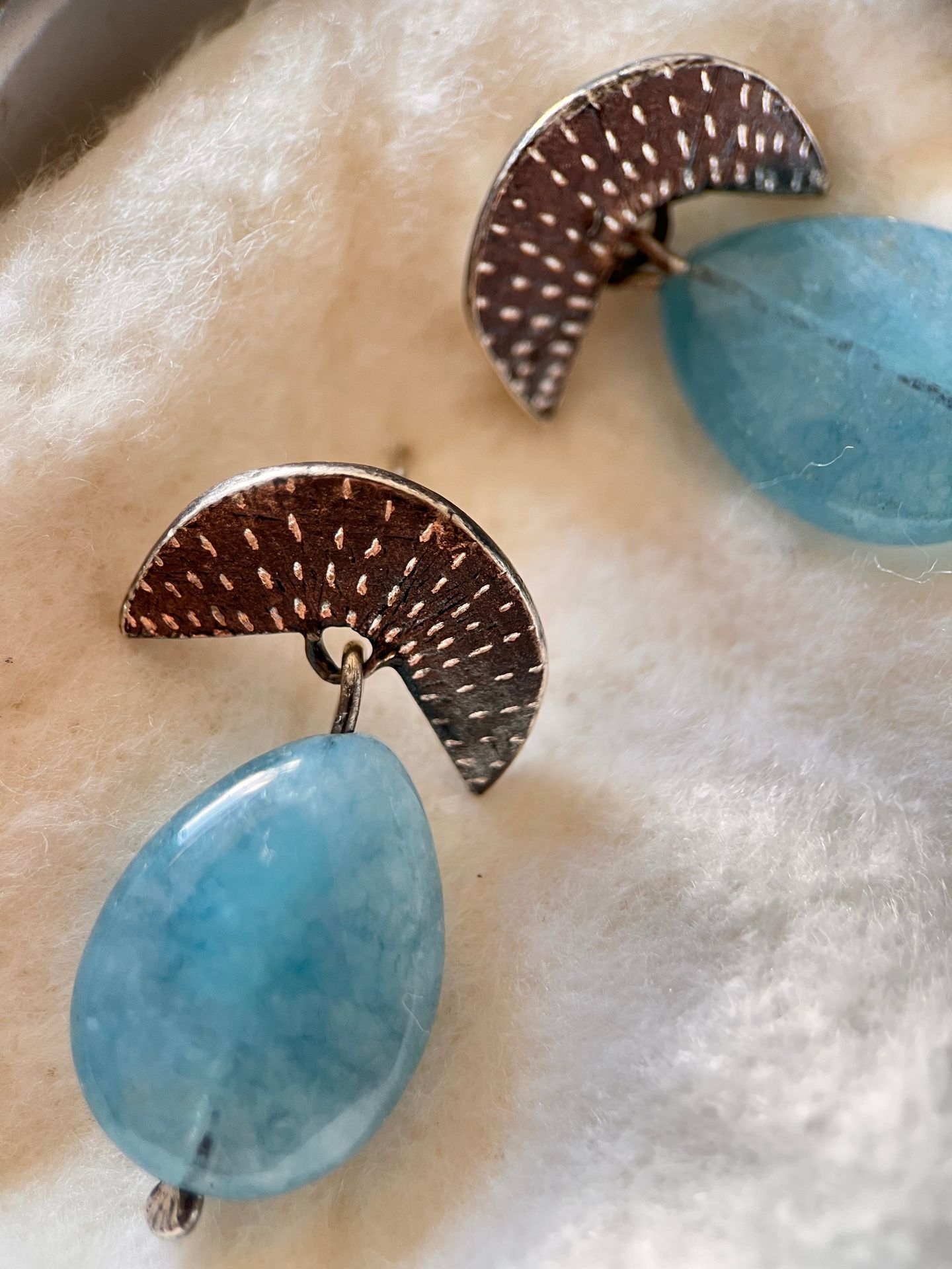 Textured half-moon silver studs with blue stone drops